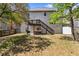 View of a two-story home and backyard with a wooden deck and stairs leading to a well-maintained lawn at 1318 Avington Glen Dr, Lawrenceville, GA 30045