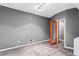 Neutral basement room showcasing carpeting and light fixture, providing a versatile space for various uses at 1318 Avington Glen Dr, Lawrenceville, GA 30045