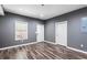 Versatile finished basement room with gray walls, recessed lighting, and modern wood-look flooring at 1318 Avington Glen Dr, Lawrenceville, GA 30045