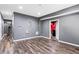 Finished basement area featuring hard surface flooring, gray walls, and access to other rooms at 1318 Avington Glen Dr, Lawrenceville, GA 30045