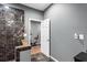 A bathroom with marble-tiled shower and a view into an exercise room with bike at 1318 Avington Glen Dr, Lawrenceville, GA 30045