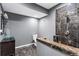 Modern bathroom features a stylish glass bowl sink, grey walls and a luxurious shower with dark marble tiles at 1318 Avington Glen Dr, Lawrenceville, GA 30045