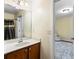 Bathroom with wooden vanity and a shower/bath combo, offering a simple and functional design at 1318 Avington Glen Dr, Lawrenceville, GA 30045
