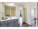 Bathroom features a vanity, white countertop, and a large mirror, with a view of a bedroom at 1318 Avington Glen Dr, Lawrenceville, GA 30045