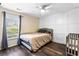 Comfortable bedroom featuring natural light, ceiling fan, stylish paneling and modern design at 1318 Avington Glen Dr, Lawrenceville, GA 30045