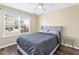 This cozy bedroom features hardwood floors and a window overlooking the neighborhood at 1318 Avington Glen Dr, Lawrenceville, GA 30045