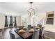Dining room featuring modern chandelier, hardwood floors, and natural light at 1318 Avington Glen Dr, Lawrenceville, GA 30045
