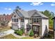 Charming two-story home with stone accents, manicured landscaping, and attached garage at 1318 Avington Glen Dr, Lawrenceville, GA 30045