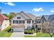 Two-story home boasts a manicured lawn, attached garage, and appealing architectural design with stone accents at 1318 Avington Glen Dr, Lawrenceville, GA 30045