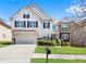 Charming two-story home with a well-maintained lawn, attached garage, and beautiful architectural details at 1318 Avington Glen Dr, Lawrenceville, GA 30045