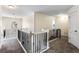 Hallway featuring black metal and white wood railings, carpet floors and bright natural light at 1318 Avington Glen Dr, Lawrenceville, GA 30045