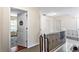 Bright hallway with carpeted floors and metal railings leading to bedrooms and other living spaces at 1318 Avington Glen Dr, Lawrenceville, GA 30045