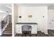 A dedicated home office space next to staircase, perfect for remote work, featuring built-in desk and storage at 1318 Avington Glen Dr, Lawrenceville, GA 30045