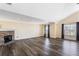 Bright living room features a stone fireplace and sleek hardwood floors, creating a cozy and modern ambiance at 1318 Avington Glen Dr, Lawrenceville, GA 30045