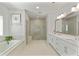 Bright, spacious bathroom with a glass-enclosed shower, a soaking tub, and double sink vanity at 2235 Chestnut Pass, Decatur, GA 30033