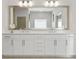 Modern bathroom vanity with double sinks, white cabinets and a large mirror at 2235 Chestnut Pass, Decatur, GA 30033