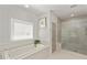 Bathroom featuring a soaking tub and a glass-enclosed shower with seat at 2235 Chestnut Pass, Decatur, GA 30033