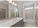 Modern bathroom with a large mirror, white countertop and marble tiled shower at 2235 Chestnut Pass, Decatur, GA 30033