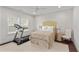 Inviting bedroom with a treadmill, neutral decor and plenty of natural light at 2235 Chestnut Pass, Decatur, GA 30033