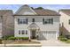 Charming two-story home with a front-facing garage and manicured landscaping at 2235 Chestnut Pass, Decatur, GA 30033
