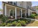 Inviting front porch with elegant columns and cozy seating area, surrounded by lush, manicured landscaping at 2235 Chestnut Pass, Decatur, GA 30033
