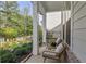 Cozy front porch showcasing comfortable wicker seating and manicured landscaping, perfect for relaxing outdoors at 2235 Chestnut Pass, Decatur, GA 30033
