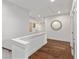Bright hallway with hardwood floors, fresh white walls, and a decorative round mirror at 2235 Chestnut Pass, Decatur, GA 30033