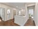 Hallway with access to laundry room and bedrooms, featuring hardwood floors and white walls at 2235 Chestnut Pass, Decatur, GA 30033