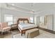 A spacious main bedroom with white tray ceilings, wood floors, and ensuite bath access at 2235 Chestnut Pass, Decatur, GA 30033