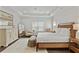 Bright main bedroom featuring tray ceilings, a large window, and a seating area at 2235 Chestnut Pass, Decatur, GA 30033