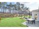 Spacious backyard featuring manicured lawn, a patio with outdoor seating and an outdoor fireplace at 307 Rockledge Sw Bnd, Powder Springs, GA 30127
