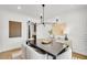 Elegant dining room featuring a modern chandelier, stylish decor, and contemporary furnishings at 307 Rockledge Sw Bnd, Powder Springs, GA 30127