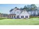 Charming two-story home featuring a spacious lawn, inviting porch, and modern architectural details at 307 Rockledge Sw Bnd, Powder Springs, GA 30127