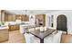 Spacious kitchen featuring an island with bar stools, stainless steel appliances, and dark wood dining set at 307 Rockledge Sw Bnd, Powder Springs, GA 30127