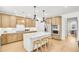 Bright kitchen features a large island with seating, stainless steel appliances, and light wood cabinets at 307 Rockledge Sw Bnd, Powder Springs, GA 30127