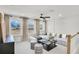 Cozy living room with plush seating, natural light, and modern ceiling fan at 307 Rockledge Sw Bnd, Powder Springs, GA 30127
