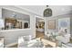 Bright living room with large windows, comfortable seating, and an open view of the kitchen at 307 Rockledge Sw Bnd, Powder Springs, GA 30127