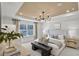 Serene main bedroom featuring tray ceiling, soft lighting, and large window at 307 Rockledge Sw Bnd, Powder Springs, GA 30127