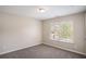 Cozy bedroom featuring plush carpeting, neutral walls, and a bright window view at 3459 Village Park Sw Ln, Atlanta, GA 30331