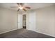 Inviting bedroom with neutral colors, a ceiling fan, and two doors to other rooms at 3459 Village Park Sw Ln, Atlanta, GA 30331
