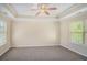 Spacious bedroom with tray ceiling, ceiling fan, carpet and natural light at 3459 Village Park Sw Ln, Atlanta, GA 30331