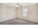Bedroom features a ceiling fan, carpet, and natural light at 3459 Village Park Sw Ln, Atlanta, GA 30331