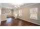 Open dining room features modern chandelier, hardwood flooring, and natural light at 3459 Village Park Sw Ln, Atlanta, GA 30331