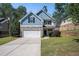 Charming two-story home with blue siding, stone accents, and a well-manicured lawn at 3459 Village Park Sw Ln, Atlanta, GA 30331