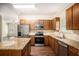 Open kitchen features stainless appliances, granite countertops and hardwood flooring at 3459 Village Park Sw Ln, Atlanta, GA 30331