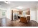 Open kitchen boasts stainless steel appliances, wooden cabinets and hardwood flooring at 3459 Village Park Sw Ln, Atlanta, GA 30331