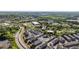 Aerial view of modern townhomes at 938 Catamaran Ct surrounded by lush green landscape and commercial district at 938 Catamaran Ct, Alpharetta, GA 30005