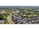 An aerial view showcasing modern townhomes surrounded by vibrant green landscaping and commercial district at 938 Catamaran Ct, Alpharetta, GA 30005