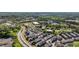An aerial view showcasing modern townhomes surrounded by vibrant green landscaping and a nearby parkway at 938 Catamaran Ct, Alpharetta, GA 30005