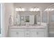 Bathroom with a double sink vanity, granite countertop, modern fixtures, and glass shower at 938 Catamaran Ct, Alpharetta, GA 30005